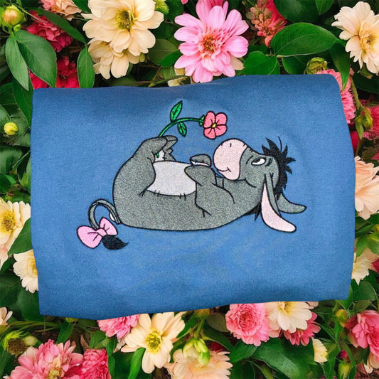 Eeyore holding a flower